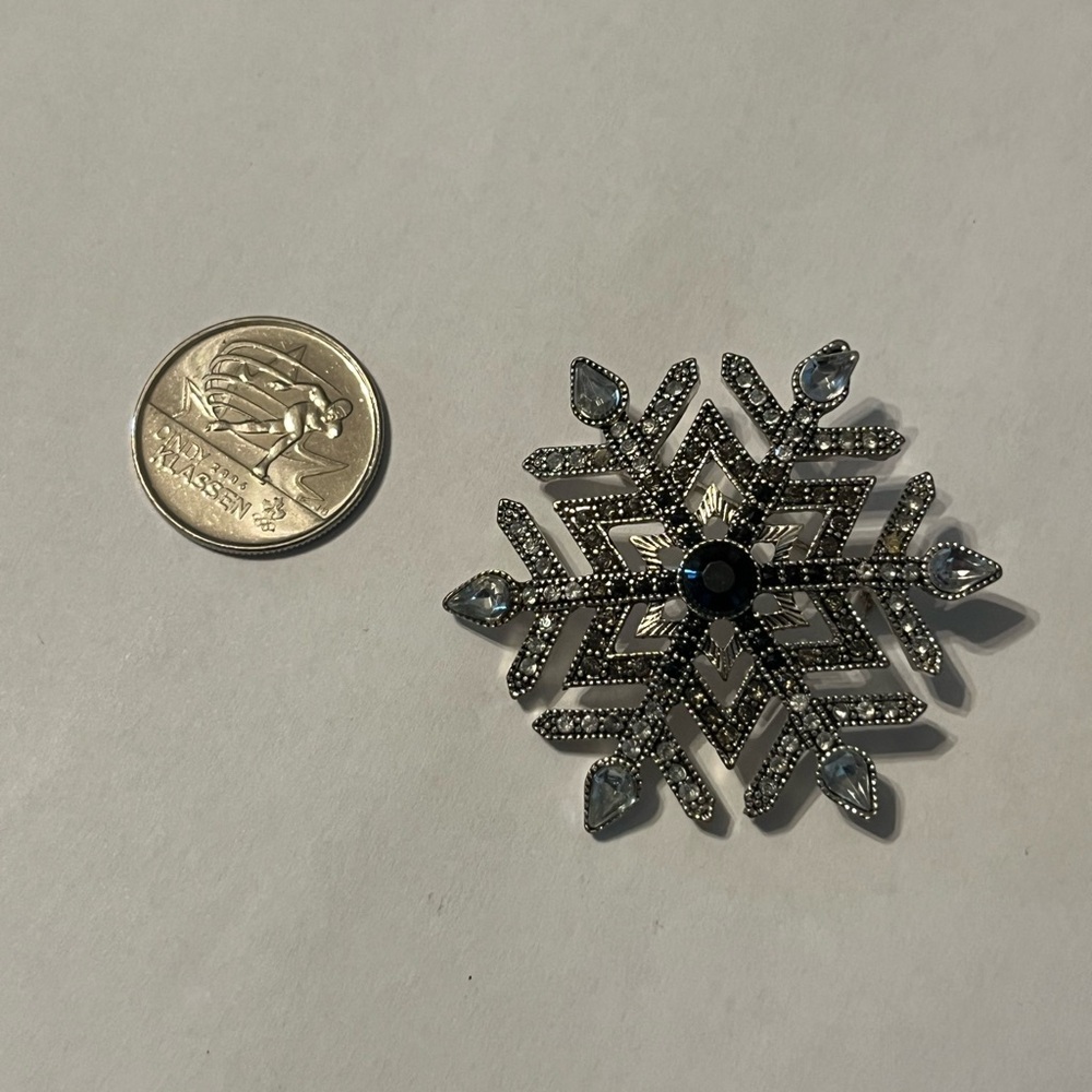 Elegant Snowflake Brooch with Blue gem Accents